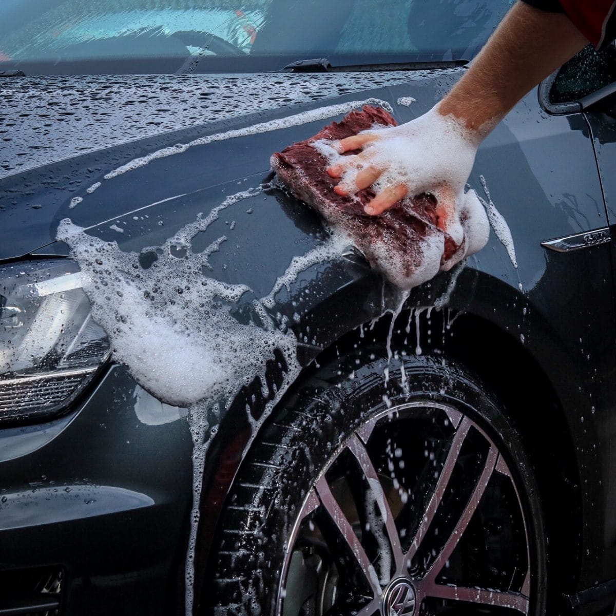 close up of man washing car