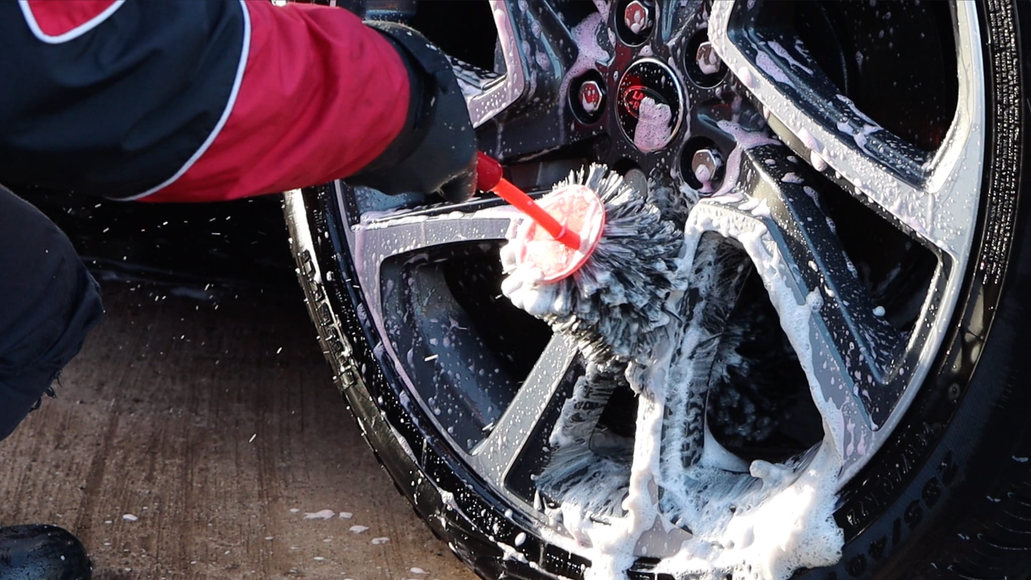 Person cleaning wheels